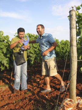 Moreno Coronica giving journalist Simon Tam a piece of his red earth